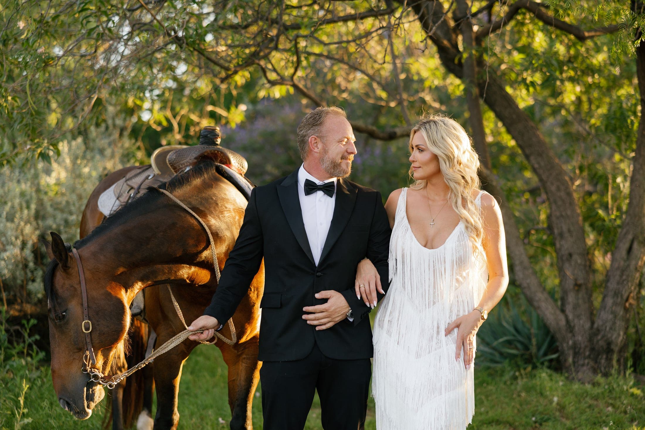 Nadia and Jason in their black-tie attire with their horse